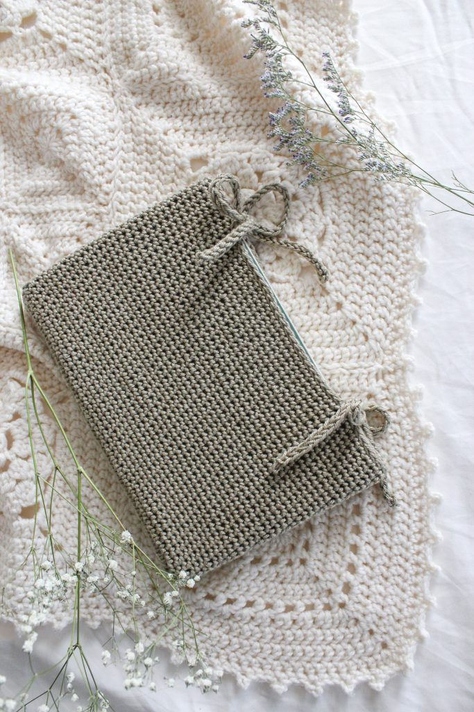 Cream color book sleeve with ribbon ties