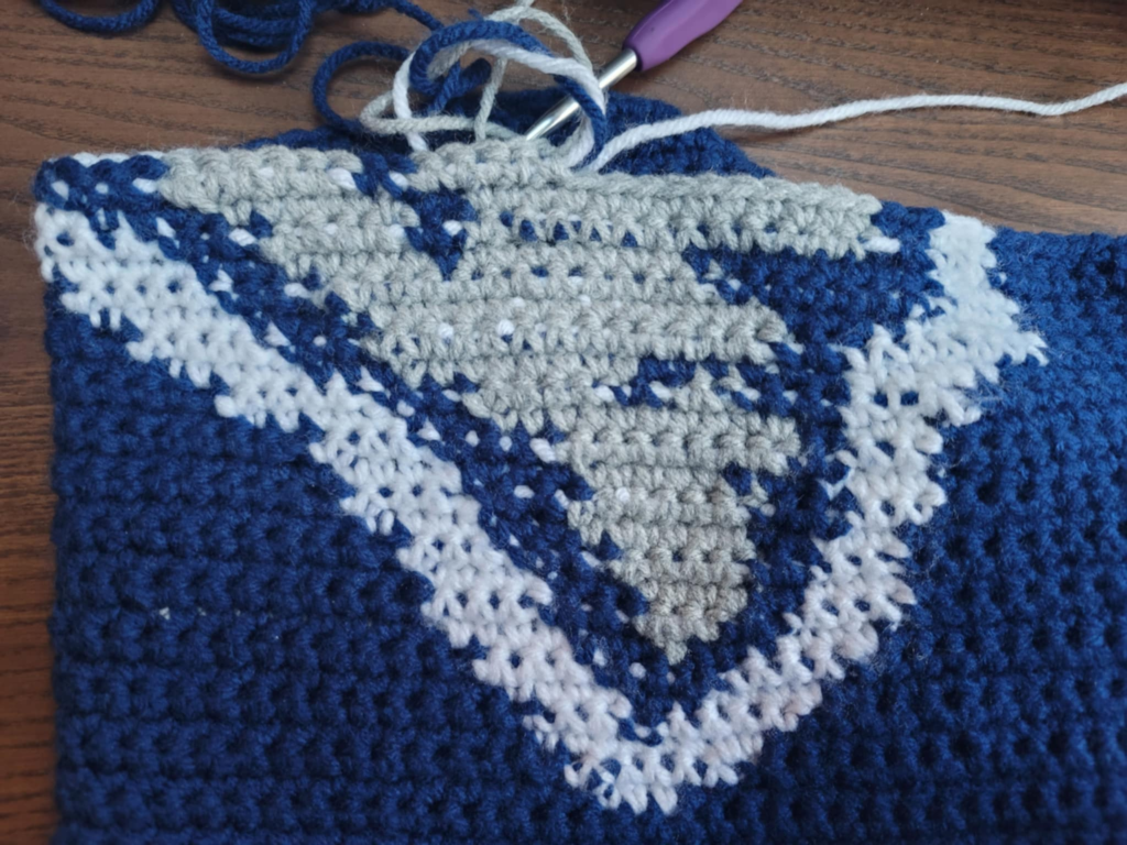 Blue, white and gray portion of the lower half of the NFL Patriot's Team's logo.